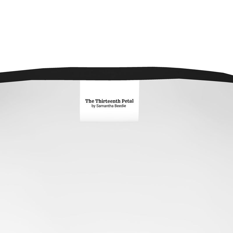 The label of The Thirteenth Petal inside a t-shirt with black collar