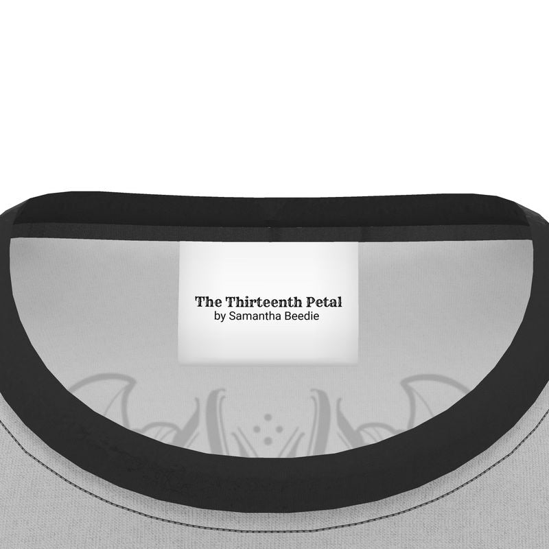 The label of The Thirteenth Petal inside a grey shirt with black collar