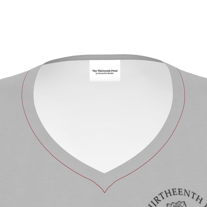 The close up of a grey v neck shirt collar the the thirteenth petal brand name on