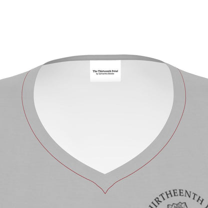 The close up of a grey v neck shirt collar the the thirteenth petal brand name on