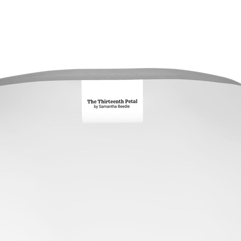 The label of The Thirteenth Petal inside a grey t-shirt