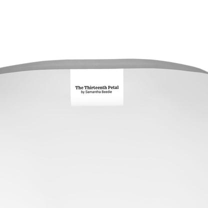 The label of The Thirteenth Petal inside a grey t-shirt