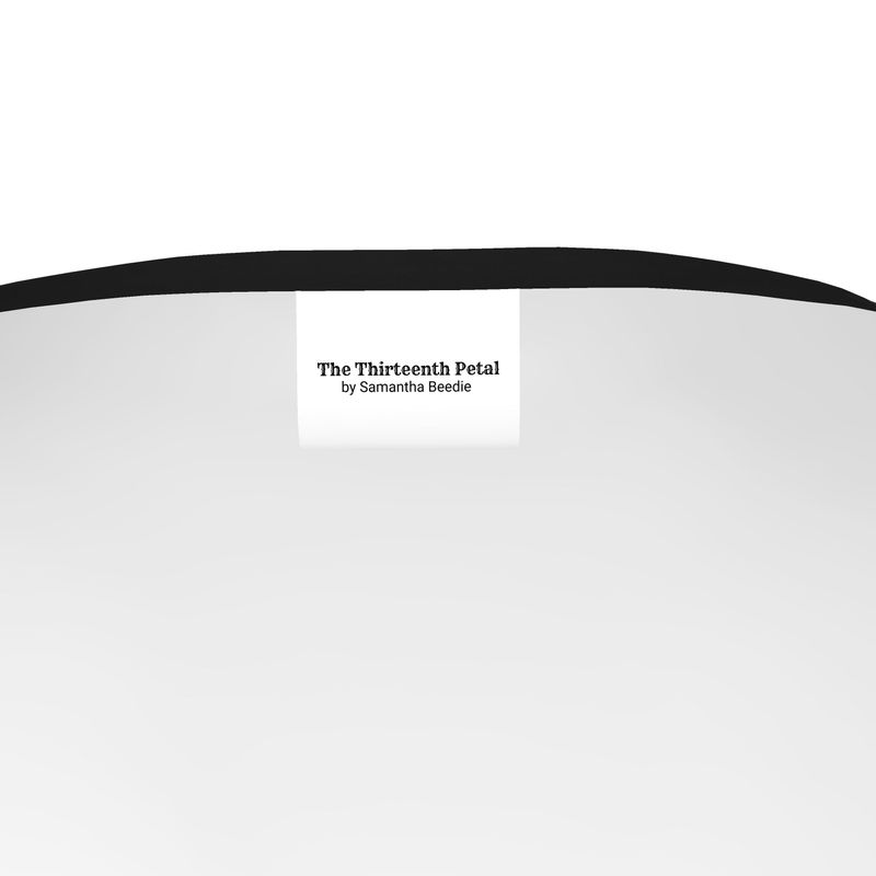 The label of The Thirteenth Petal inside a black shirt with black collar