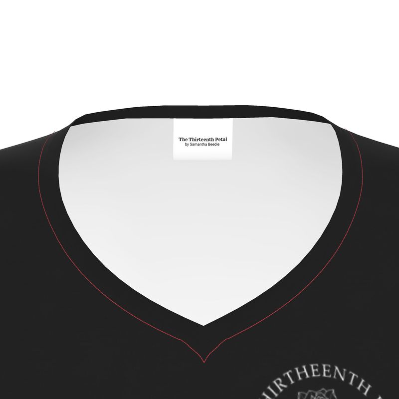 The close up of a black v neck shirt collar the the thirteenth petal brand name on