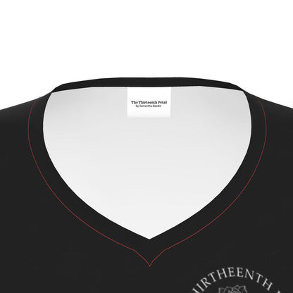 The close up of a black v neck shirt collar the the thirteenth petal brand name on