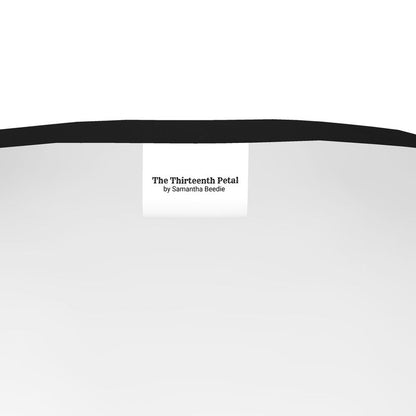 The label of The Thirteenth Petal inside a t-shirt with black collar